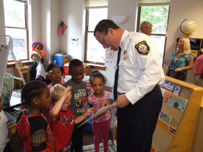 Albany Police Chief Steve Krokoff reads to children at Joseph L. Bruno Family Resource Center in Troy